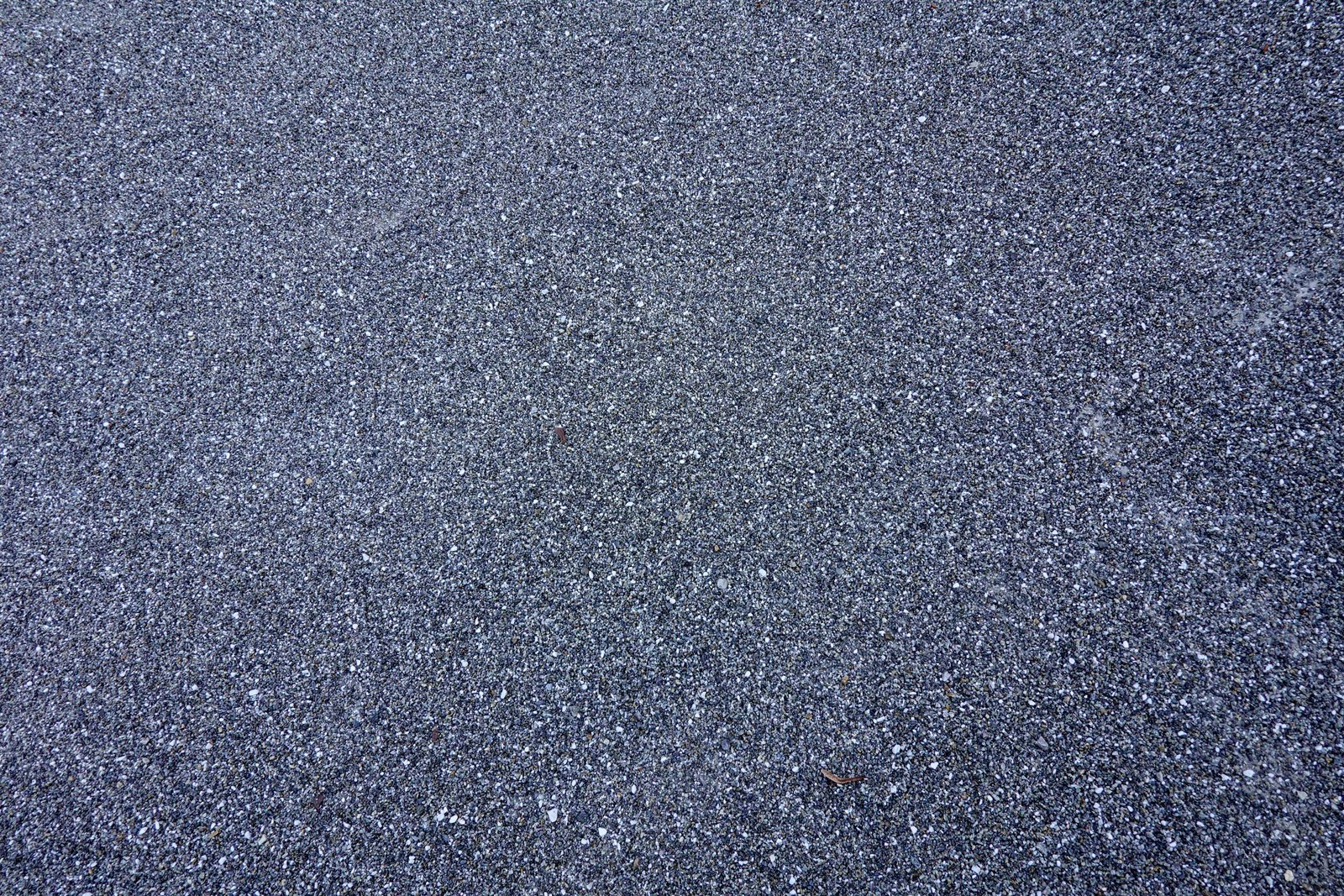 Driveway and patio installer laying block paving in front of house