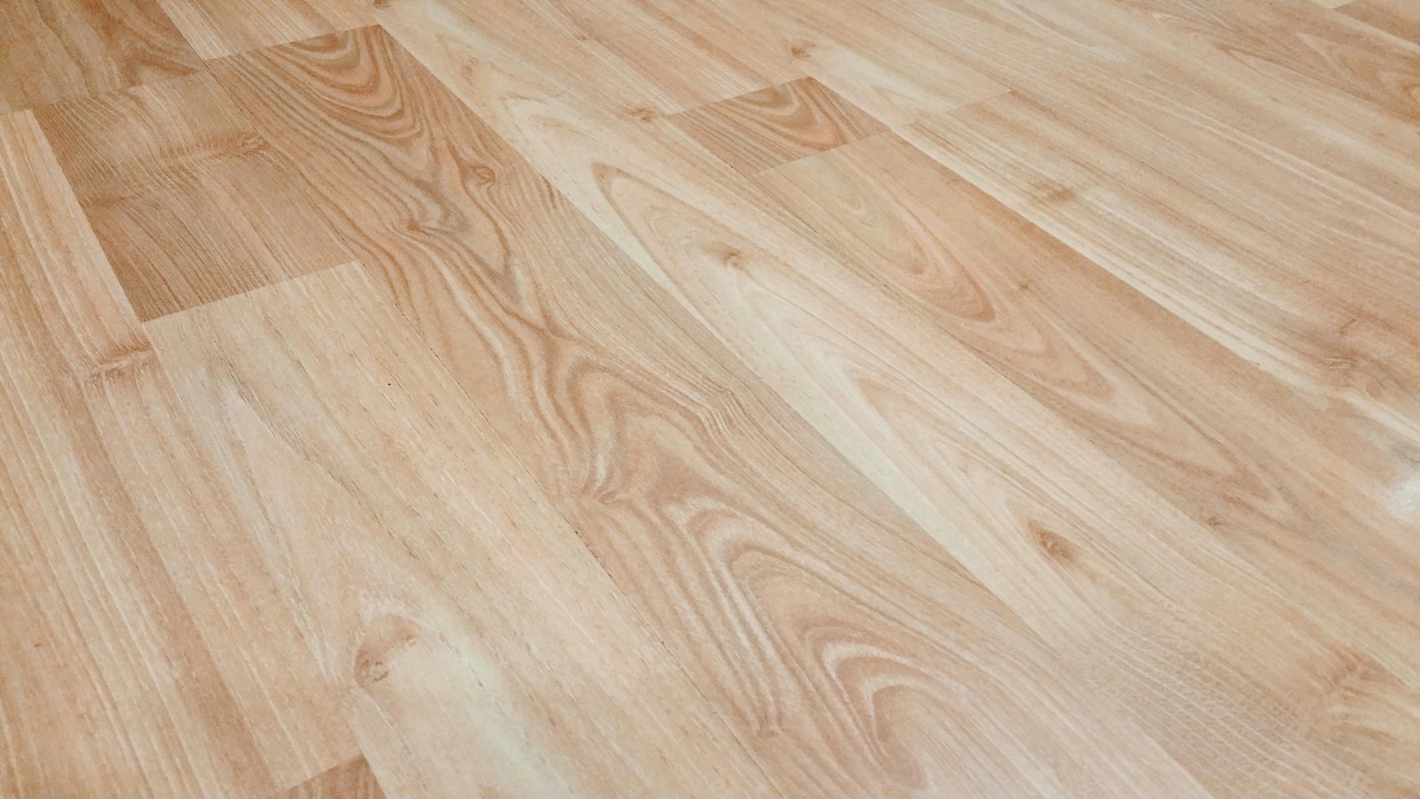 Flooring specialist installing wooden planks in modern home
