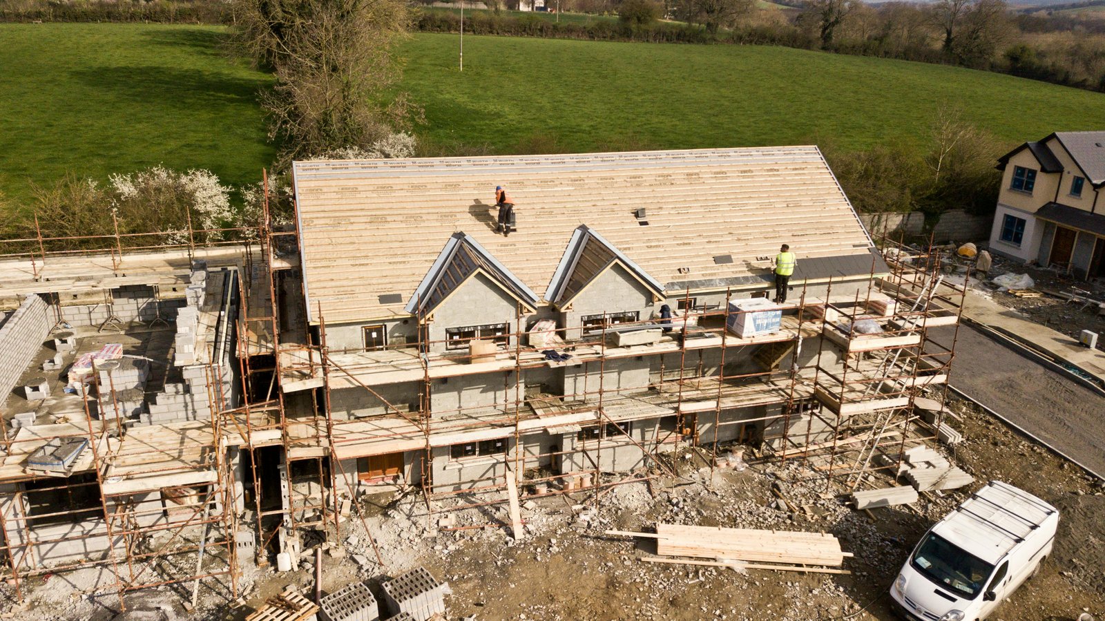 Roofer installing shingles on a house roof